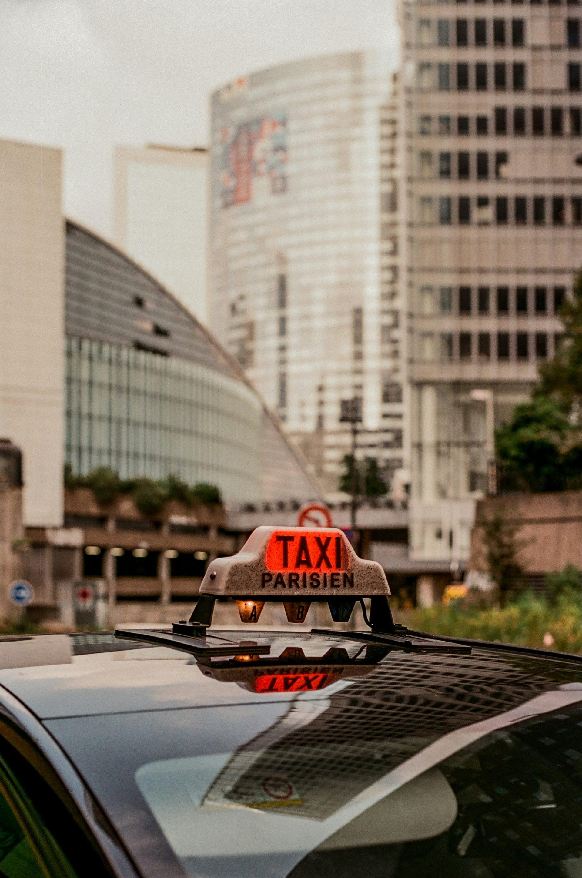 A taxi cab with a taxi sign on top of it